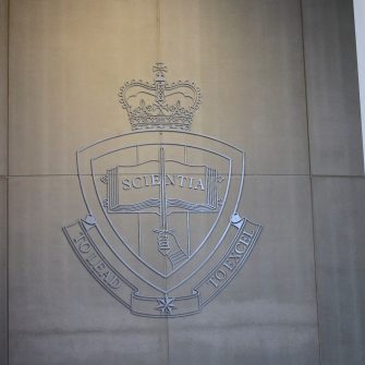 ADFA coat of arms on a wall outside Adams Auditorium UNSW Canberra